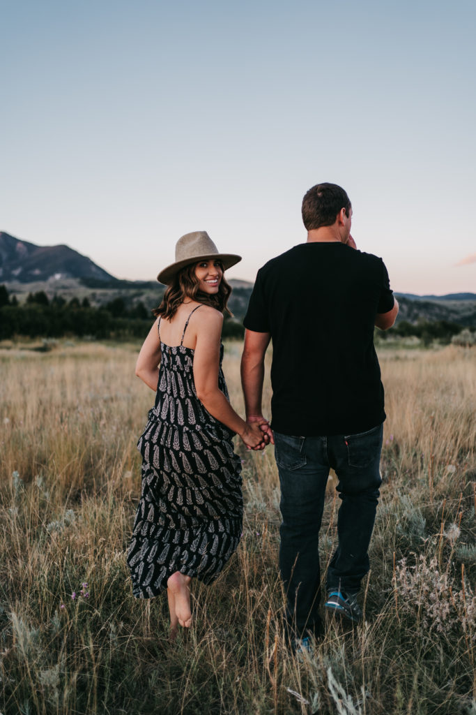 An engaged couple at sunset on a mountain in Bozeman, Montana.