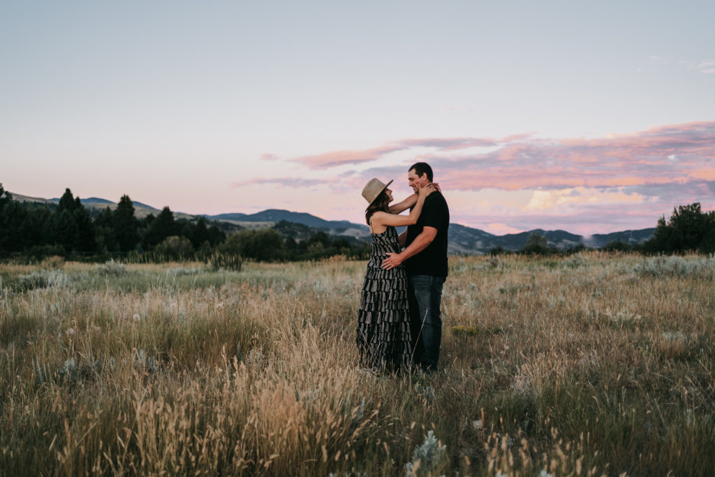 An engaged couple at sunset on a mountain in Bozeman, Montana.
