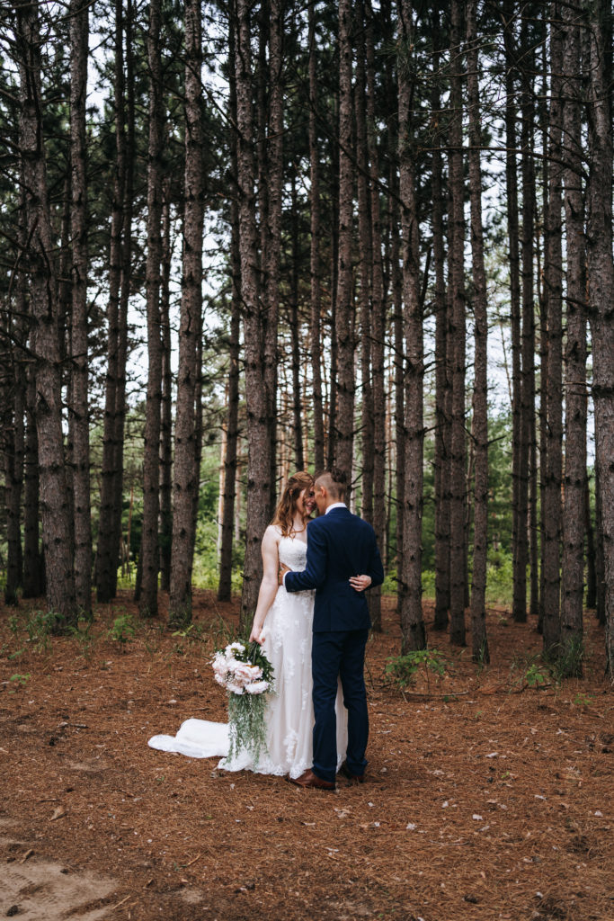 Bride and groom among the pine trees in Northern Minnesota