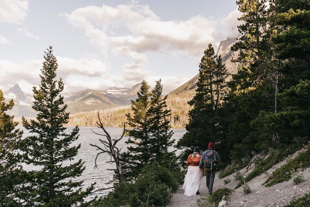 Glacier National Park elopement. Bride and groom hiking after their ceremony.