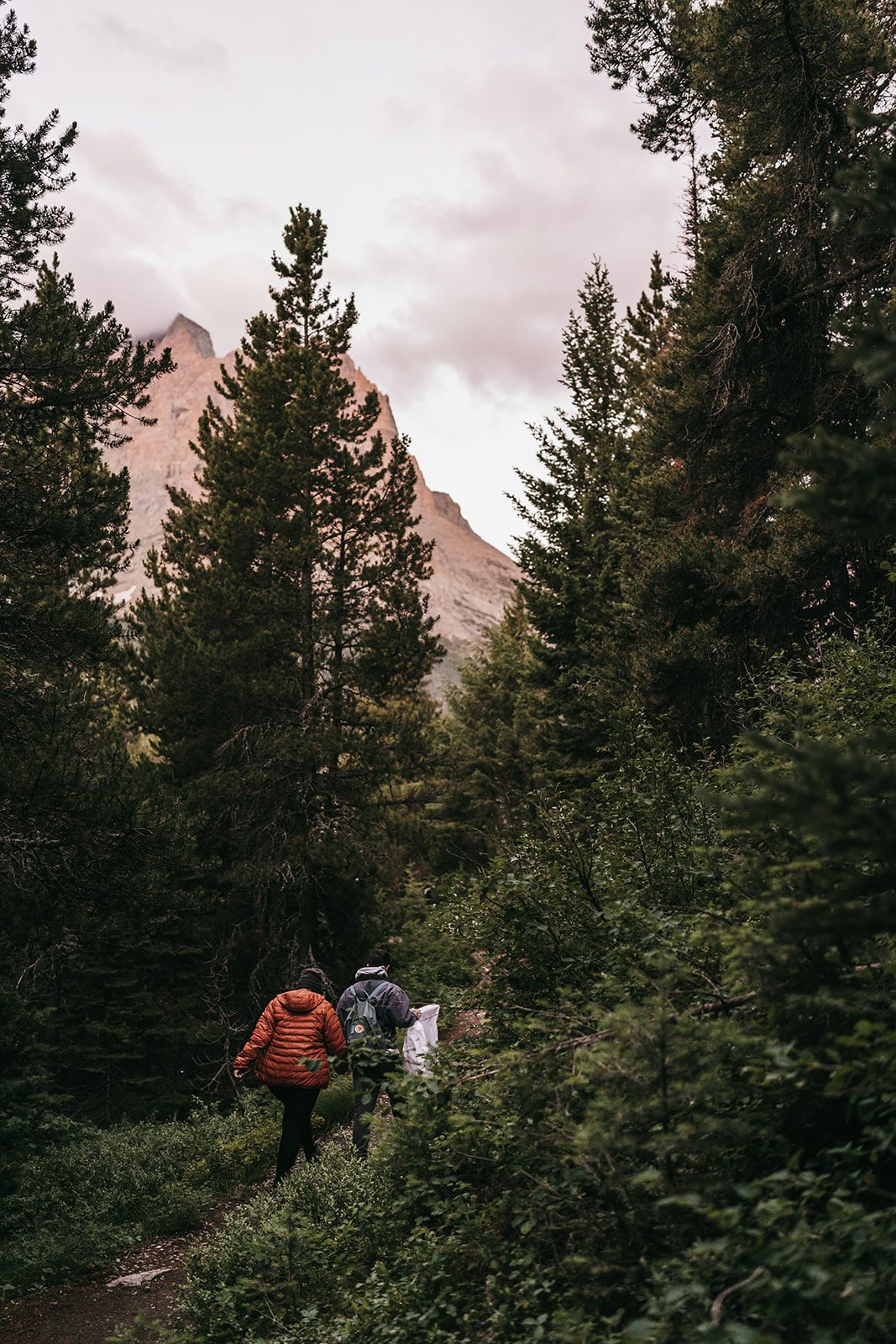 Bride and groom hiking in Glacier National Park during their elopement
