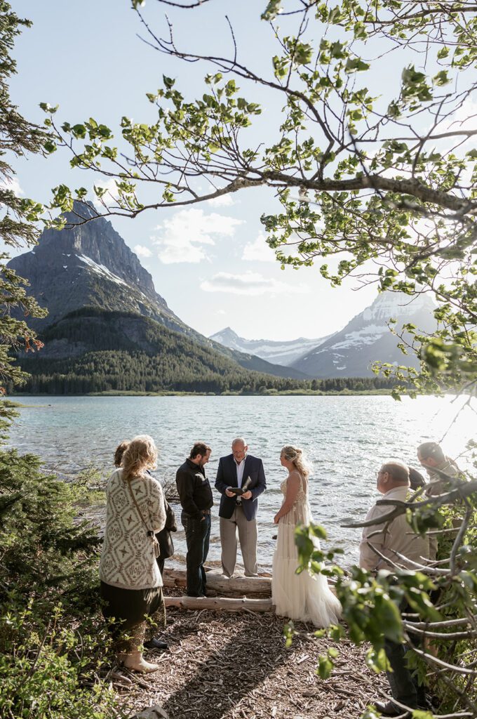 Intimate wedding ceremony at Many Glacier Hotel Beach