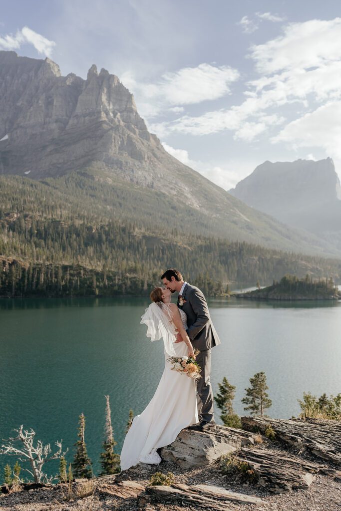 Newlyweds share a kiss at Sun Point, overlooking St. Mary Lake in Glacier National Park.