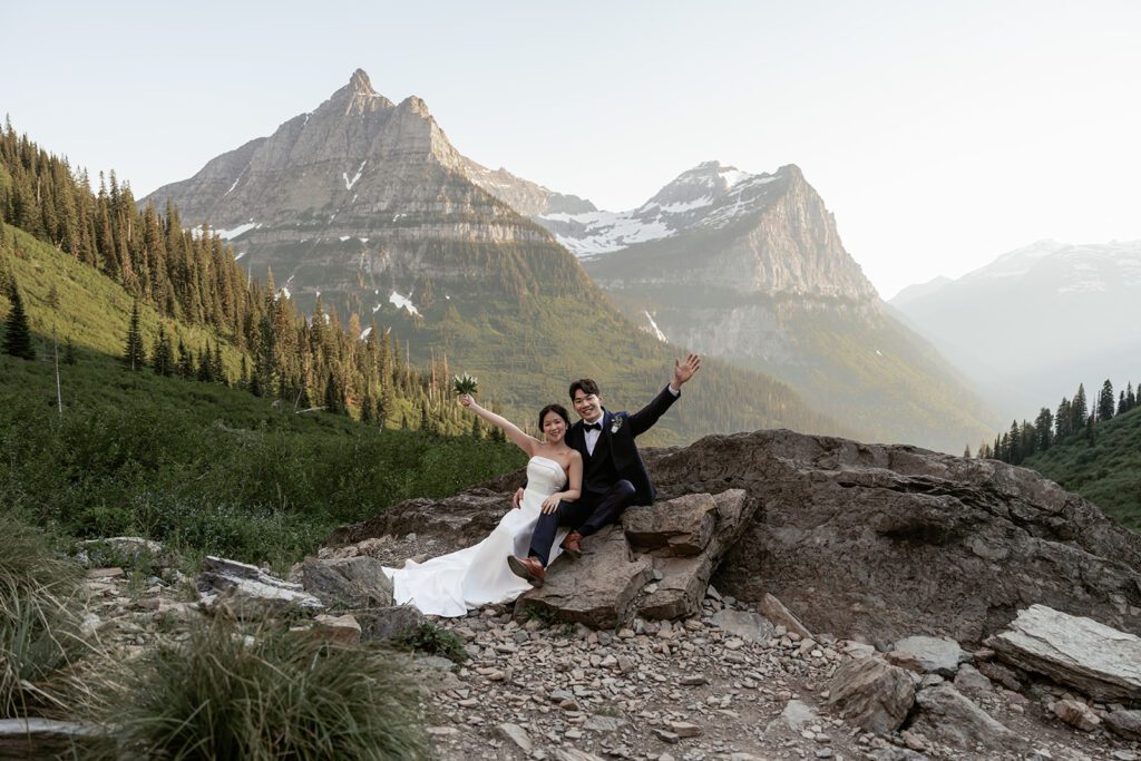 A classic bride and groom take in the views of Big Bend in Glacier National Park during a whimsical evening adventure session