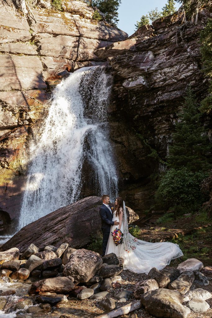 Bridal portraits at Baring Falls in Glacier National Park following an intimate ceremony at Sun Point 