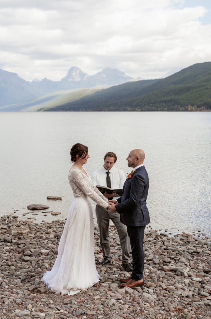 Intimate wedding ceremony at Ryan Beach, Lake McDonald in Glacier National Park photographed by Sydney Breann Photography