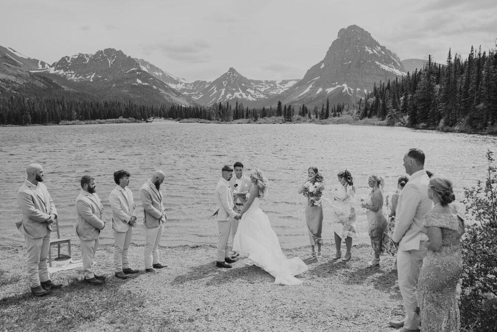 A windy early summer wedding ceremony at Pray Lake in Glacier National Park, photographed by Sydney Breann Photography.