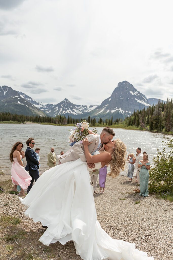 A windy early summer wedding ceremony at Pray Lake in Glacier National Park, photographed by Sydney Breann Photography.
