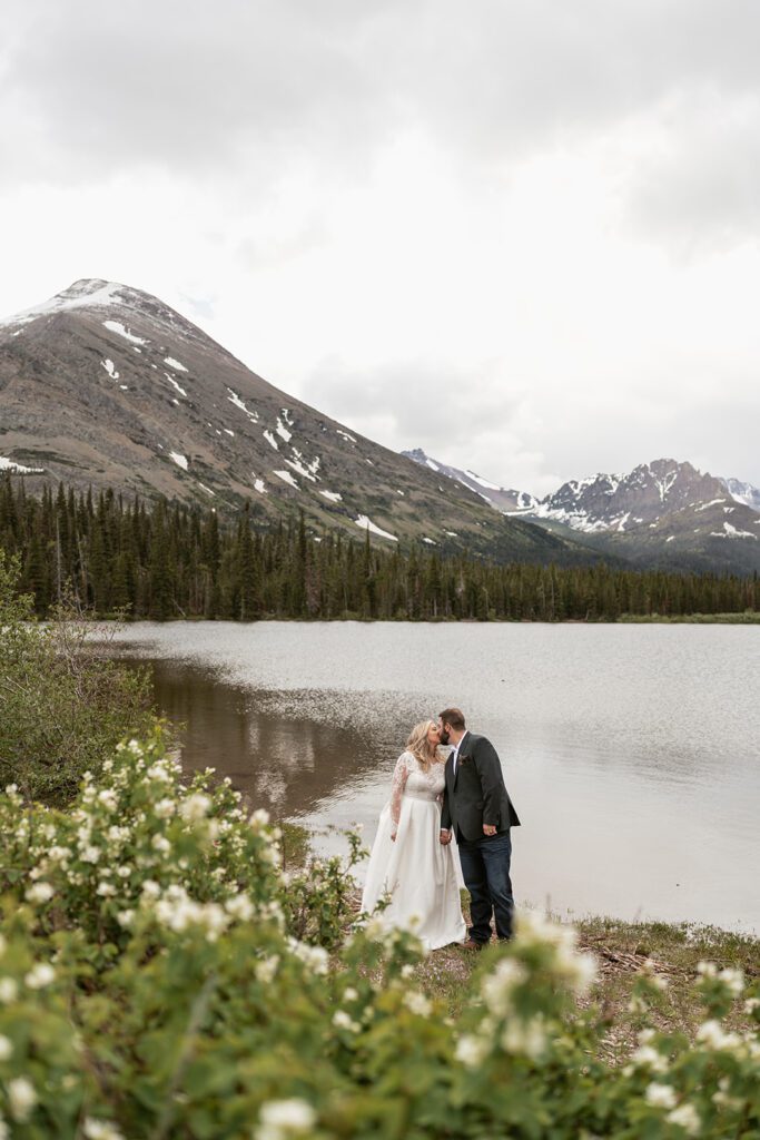 Bride and groom exchange private vows at Pray Lake during their intimate wedding ceremony in Glacier National Park, photographed by Sydney Breann Photography.