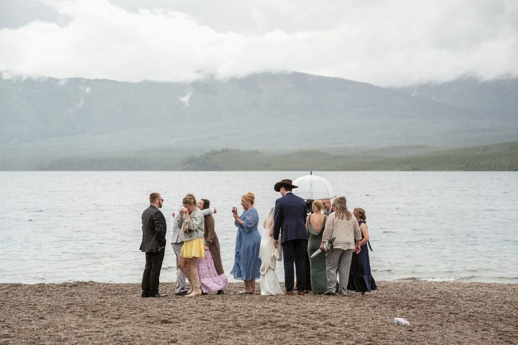Emotional intimate wedding ceremony at Lake McDonald in Glacier National Park photographed by Sydney Breann Photography.