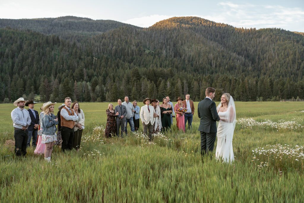 Intimate sunrise wedding ceremony at Durnam Meadow in Big Sky, Montana photographed by Sydney Breann Photography.
