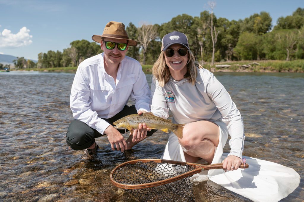 Newlyweds fly fish on the Yellowstone River during their adventurous Montana elopement photographed by Sydney Breann Photography.