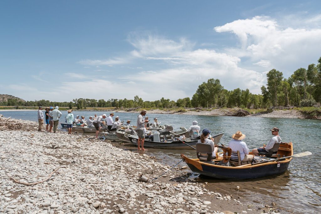 Newlyweds fly fish on the Yellowstone River during their adventurous Montana elopement photographed by Sydney Breann Photography.