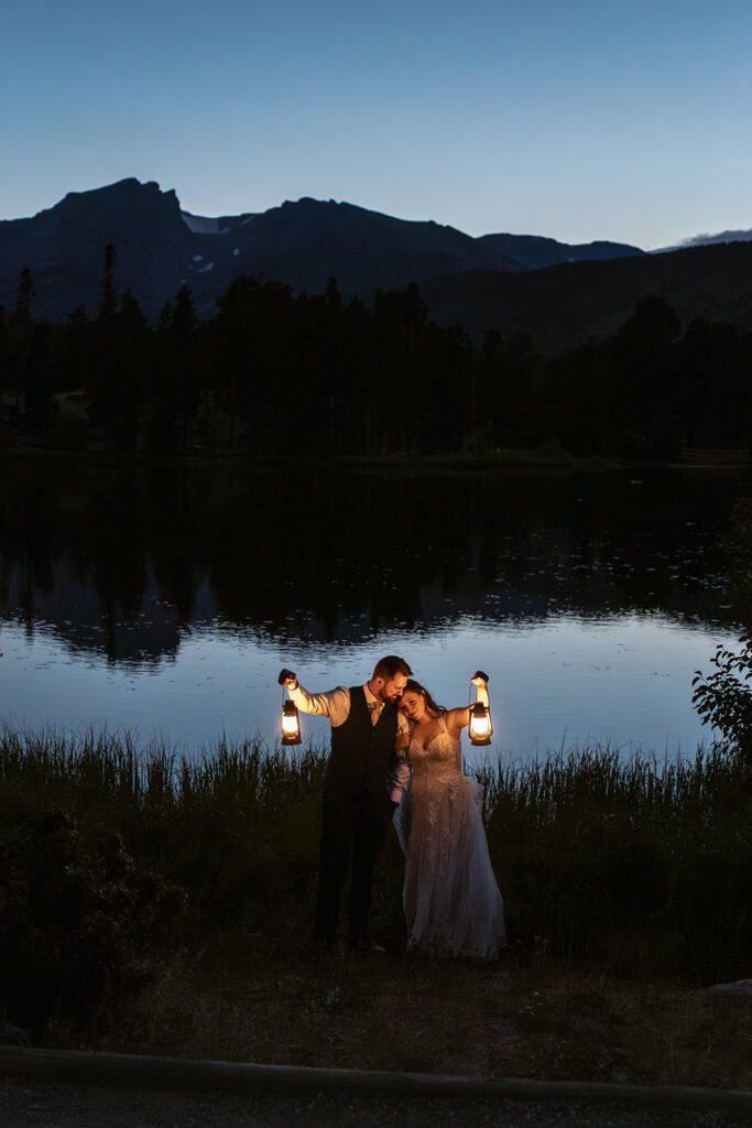 Newlyweds enjoy blue hour at Sprague Lake by the light of lanterns