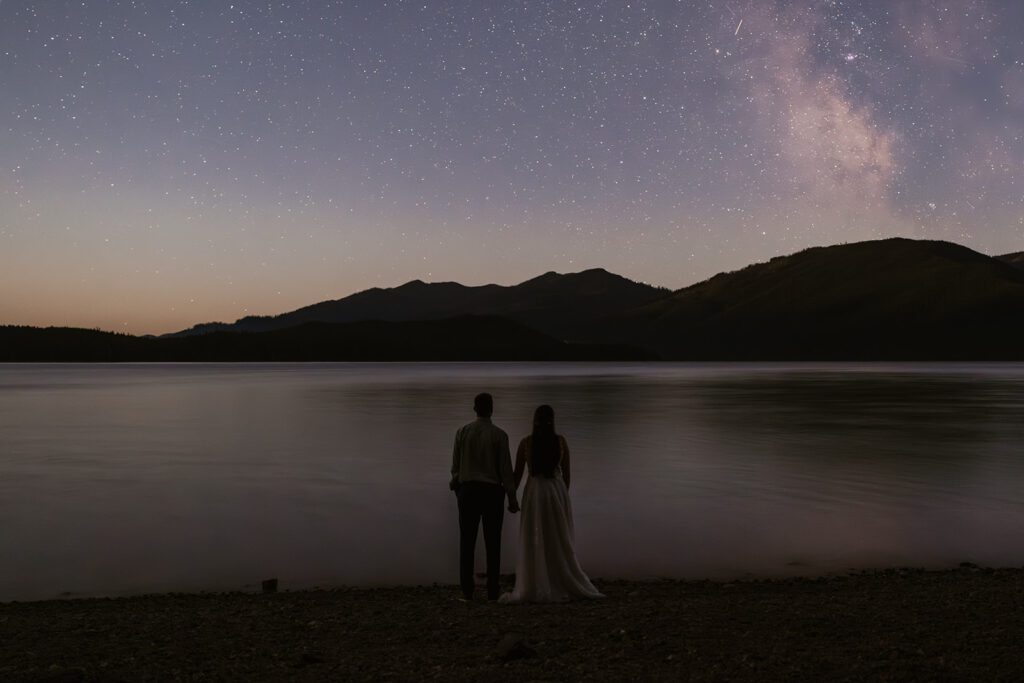 Newlyweds end their elopement at Ryan Beach with stargazing in Glacier National Park, photographed by Sydney Breann Photography