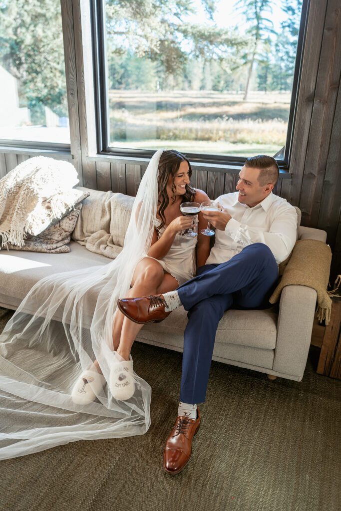 A bride and groom sip espresso martinis on their wedding morning