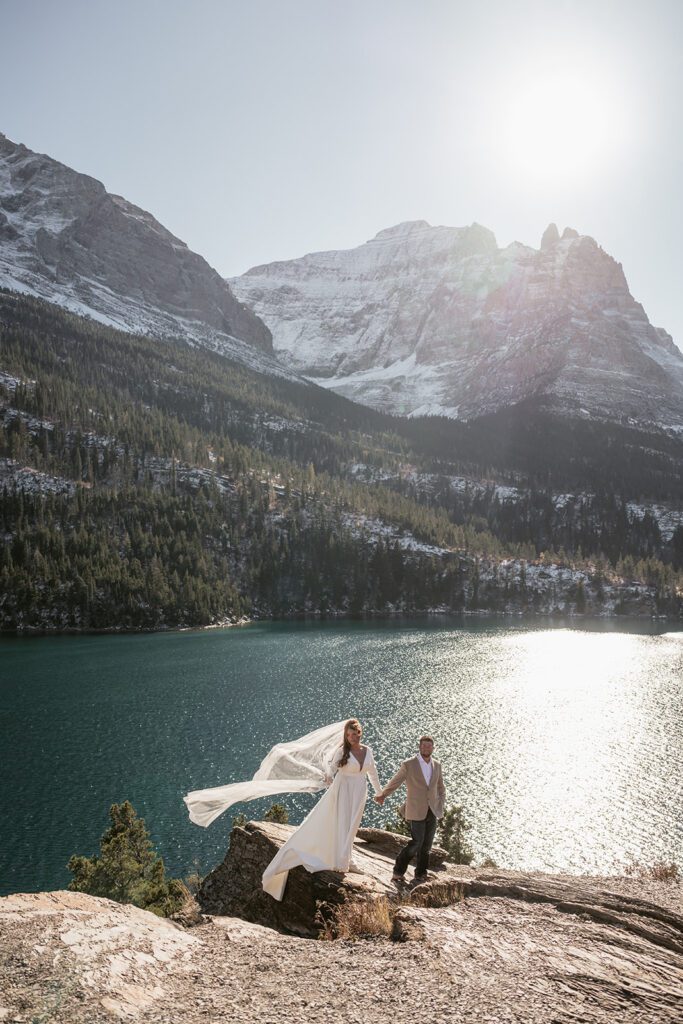 Bride and groom newlywed portraits overlooking St. Mary Lake from Sun Point